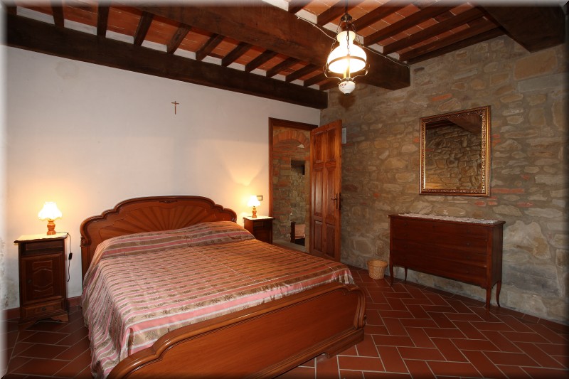 bedroom with view of the courtyard of farmhouse Poggiolo on the ground floor