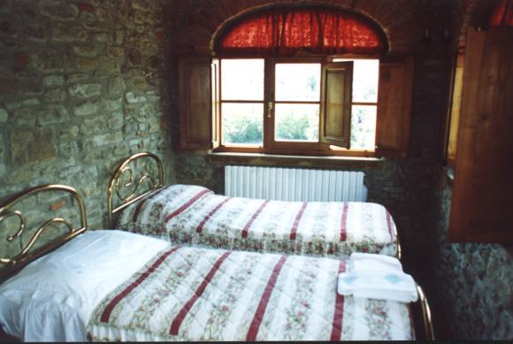 bedroom with view of the courtyard of San Savino villa upstairs