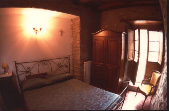 bedroom with view of the courtyard of Agriturismo San Savino on the ground floor